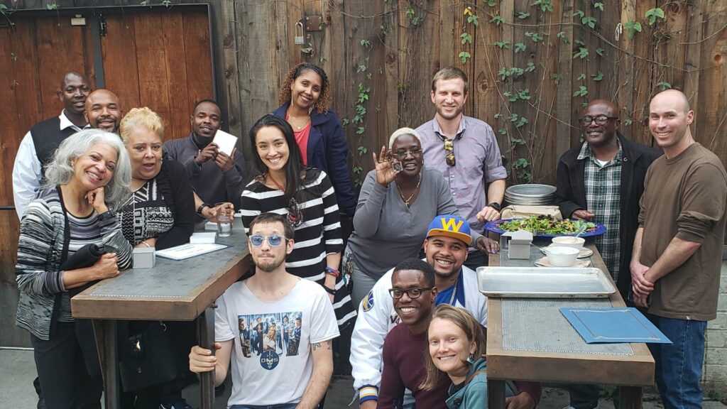 A group of smiling people gathered over a meal